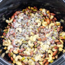 In a slow cooker, create a delightful Cheese It Snack Mix by blending mixed nuts with grated cheese and your favorite seasonings.