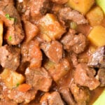 Close-up of a bowl filled with venison stew, featuring tender chunks of meat and potatoes in a rich, brown sauce—a hearty recipe perfect for any comfort food lover.