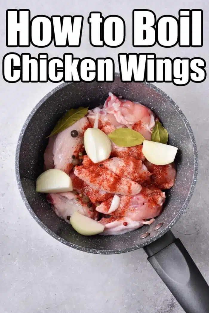 A pot containing boiled chicken wings with onion pieces, bay leaves, and spices. The text reads "How to Boil Chicken Wings" in bold letters above the pot. The pot is placed on a gray surface.