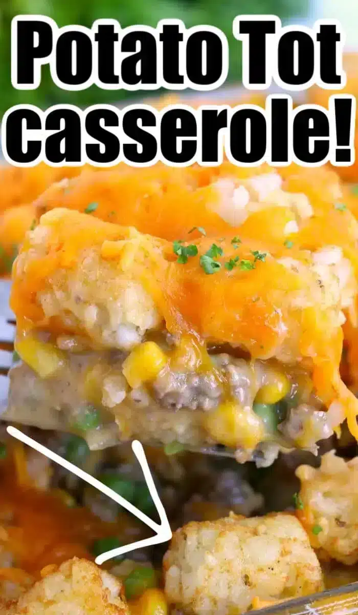 A close-up of a potato tot casserole with a portion lifted by a spatula. The dish showcases golden potato tots, melted cheese, ground beef, corn, peas, and a creamy filling. Text above reads, "Potato Tot Casserole delight!