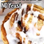 A close-up of a cinnamon roll muffin topped with white icing showcases its golden brown beauty. The text reads "Cinnamon Roll Muffins NO Yeast," highlighting the irresistible swirls of cinnamon in every bite.