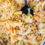 A close-up of black-eyed peas and tender cabbage cooked to perfection, with a spoon resting invitingly in the pot.