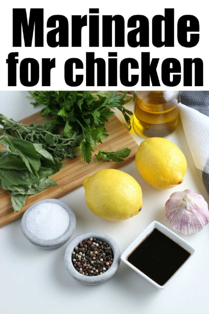 Ingredients for lemon pepper chicken marinade: a zesty blend of herbs, fresh lemons, garlic, olive oil, salt, pepper, and soy sauce on a pristine white surface.