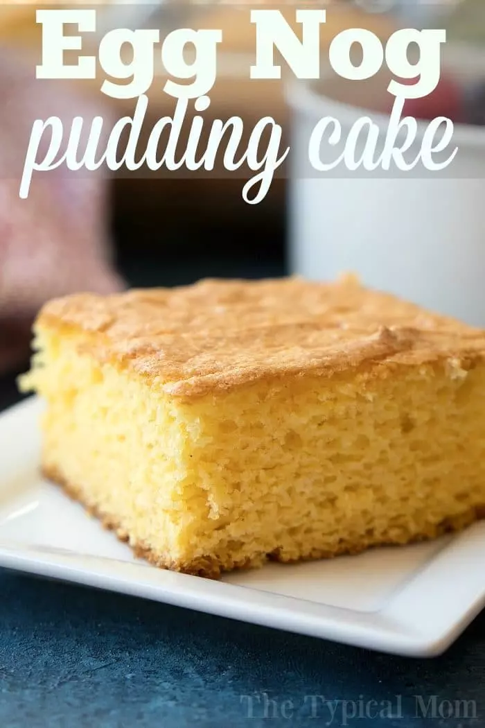 A close-up photo of a slice of eggnog pudding cake on a white square plate.