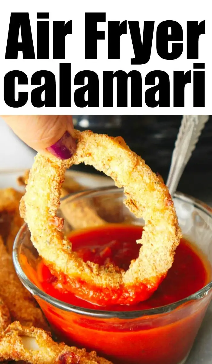 A person's hand dipping a piece of fried calamari into a bowl of red dipping sauce. The text "Air Fryer Calamari" is written in bold letters at the top of the image, showcasing the perfect appetizer before trying air fryer tilapia for dinner.