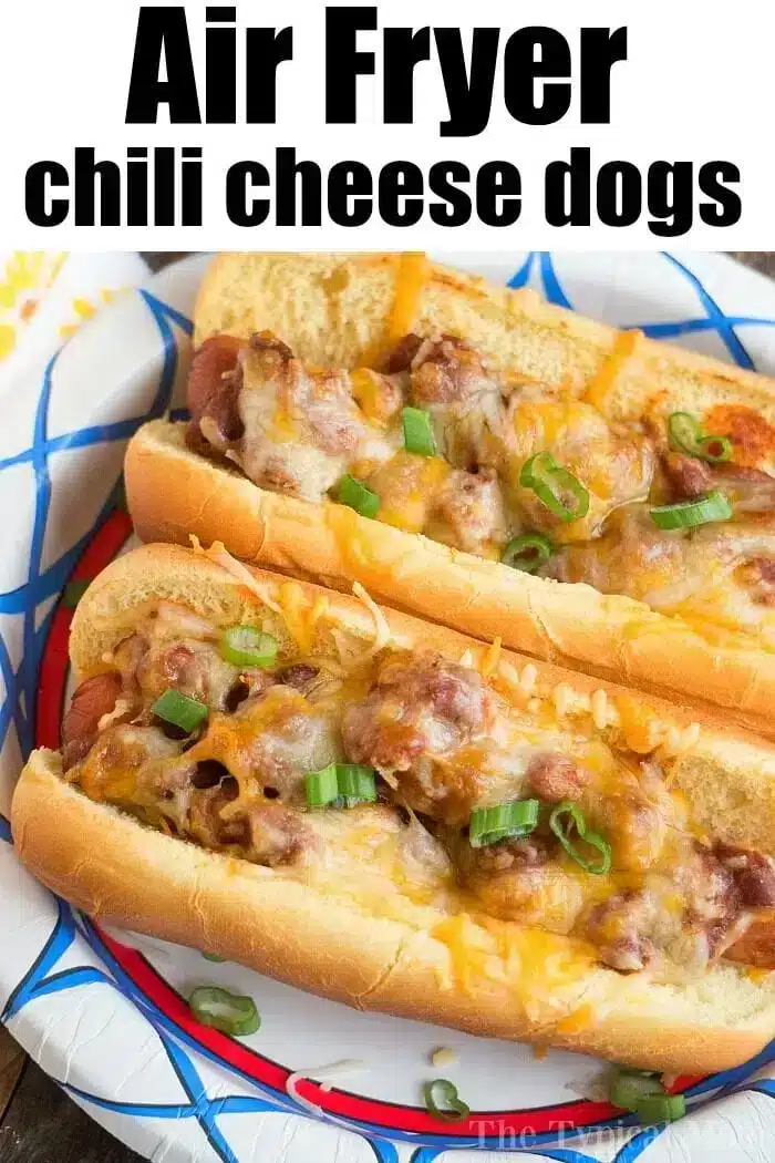 Two chili cheese hot dogs topped with melted cheese and sliced green onions are displayed on a decorative plate. The image proudly features the text "Air Fryer Hot Dogs with Chili Cheese" at the top.