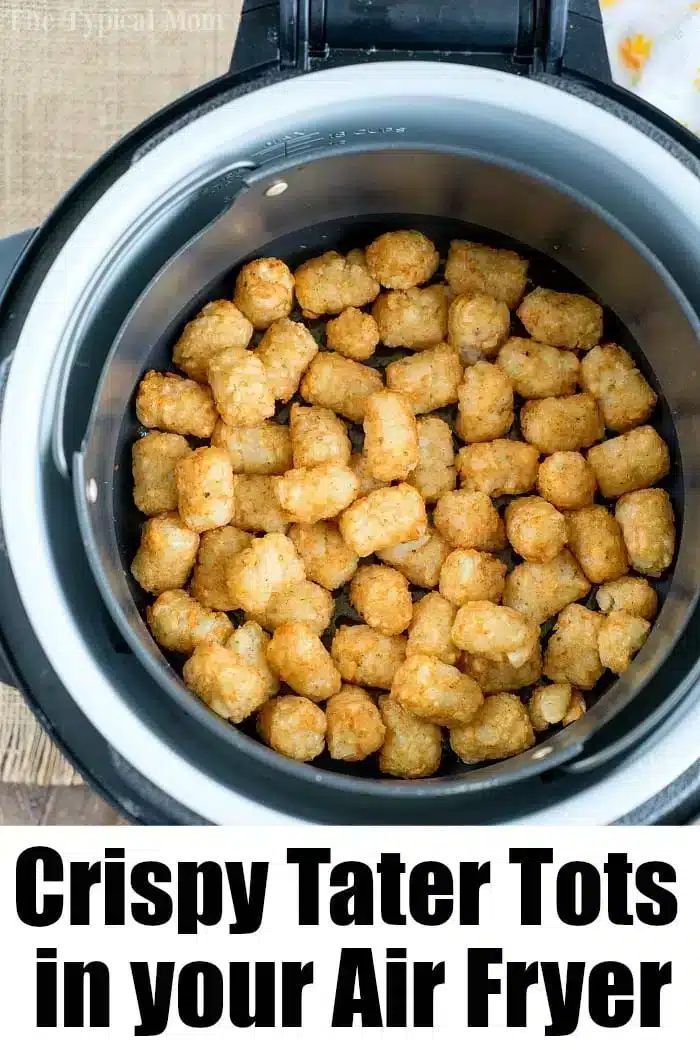 Top-down view of a batch of crispy tater tots inside an air fryer basket. The tater tots appear golden and evenly cooked, perfect to enjoy alongside your favorite air fryer hot dogs. The image has a caption reading, "Crispy Tater Tots in your Air Fryer.