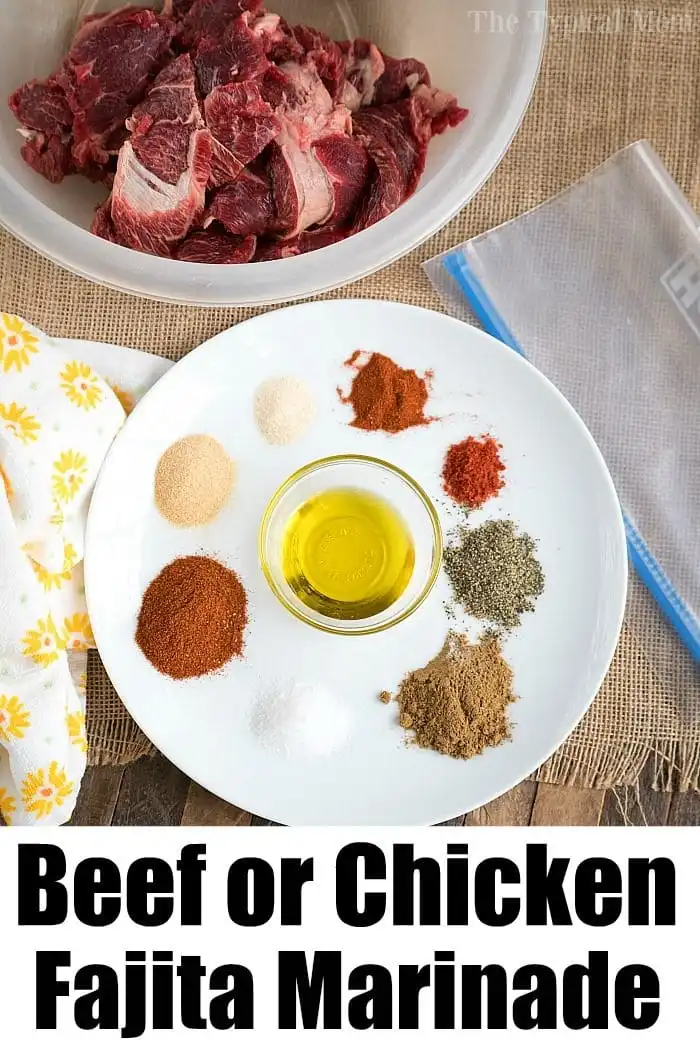 A plate with various spices and a small bowl of olive oil is arranged on a table, promising the best fajita marinade. In the background, there is a bowl with cuts of raw meat. A text at the bottom reads "Beef or Chicken Fajita Marinade.