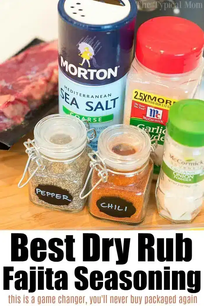 Close-up of various seasonings for fajita dry rub and the best fajita marinade, featuring a bag of beef, coarse sea salt, jars labeled "pepper" and "chili," garlic powder, and Mrs. Dash seasoning; text reads "Best Dry Rub Fajita Seasoning.