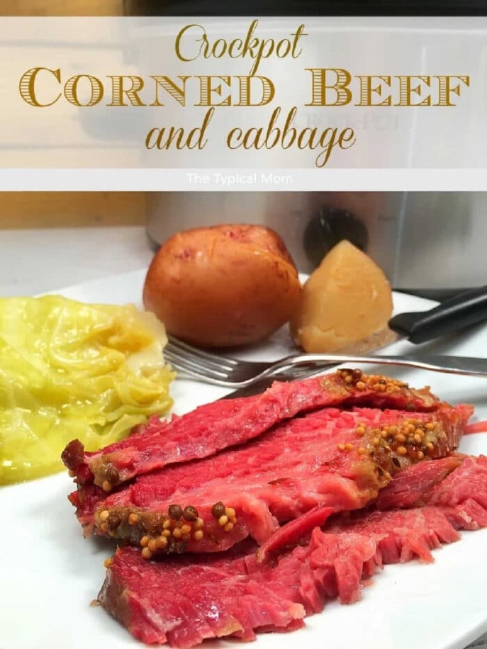 Slow cooker corned beef brisket is amazing! If you want to know how to cook corned beef brisket and cabbage in the crockpot it's super easy to do and should definitely be made more often than just on St. Patrick's Day. #cornedbeef #cabbage #slowcooker #crockpot #easy #crockpotrecipes #cornedbeefandcabbage Sliced slow cooker corned beef brisket with mustard seeds, cabbage, and potatoes on a plate in front of a crockpot.