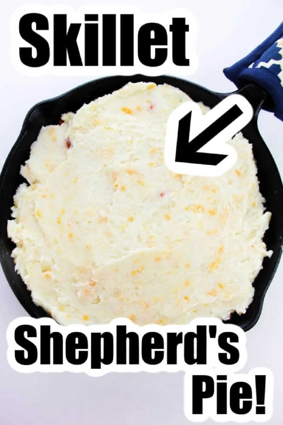 A skillet filled with mashed potatoes labeled Shepherd's Pie with Instant Potatoes! with a bold arrow pointing to it.