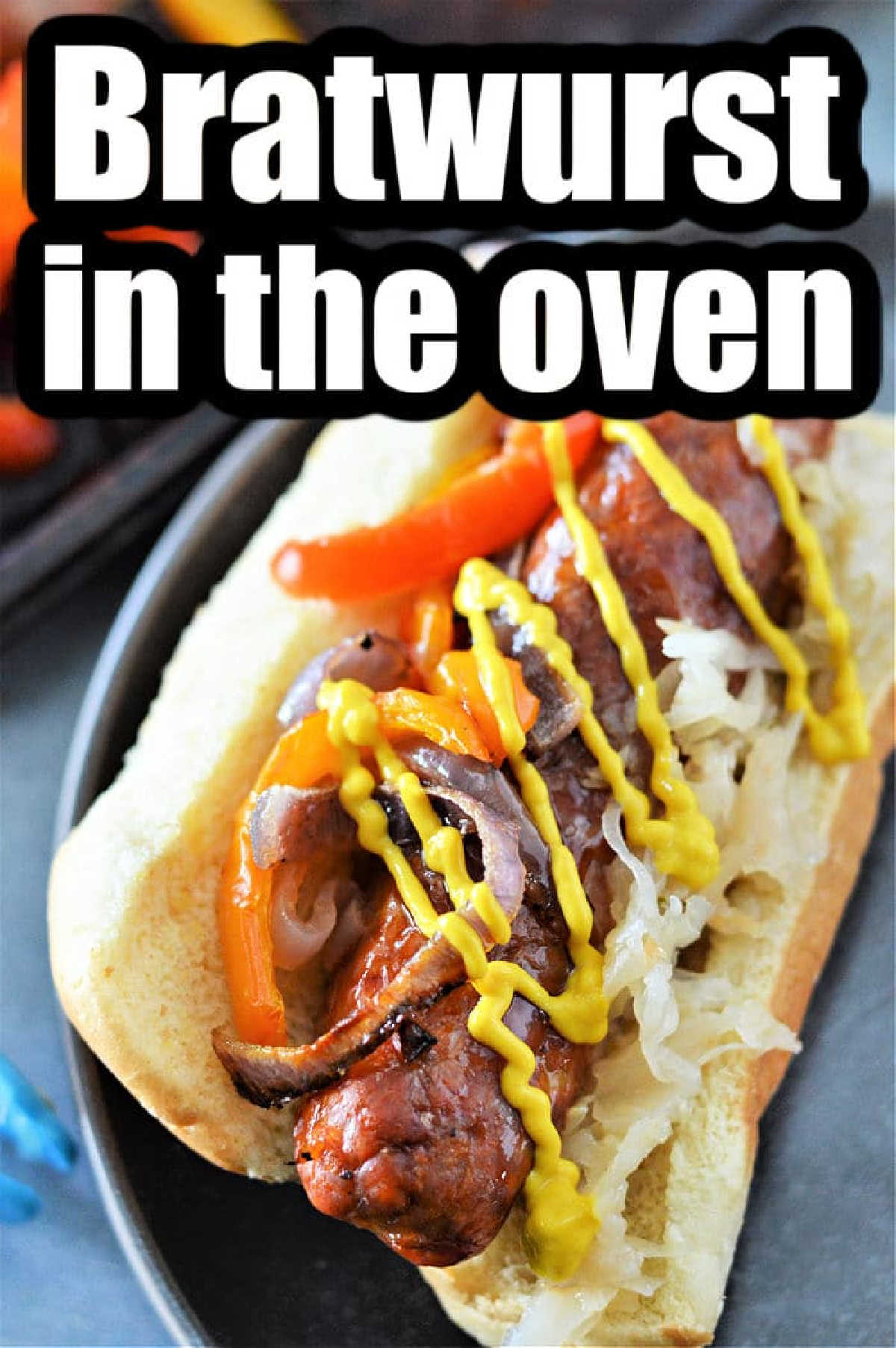 Bratwurst sausage in a bun with sauerkraut, peppers, onions, and mustard—perfect for learning how to cook bratwurst in the oven.