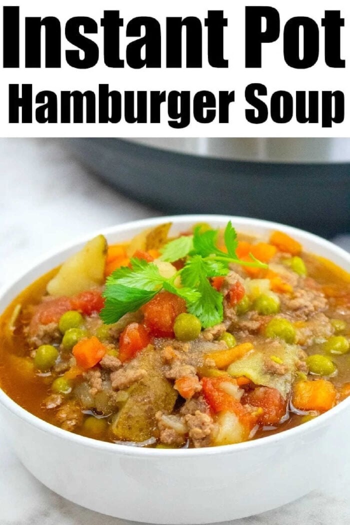 Instant Pot hamburger soup recipe with vegetables, potatoes and more! A healthy protein packed pressure cooker soup with ground beef we love is here! Bowl of hearty Instant Pot Hamburger Soup with potatoes, peas, carrots, tomatoes, and parsley, labeled Instant Pot Hamburger Soup with Potatoes.