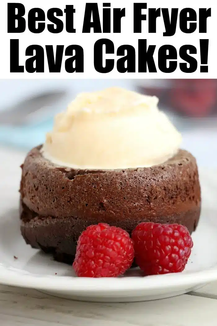 Chocolate lava cake topped with vanilla ice cream, served with two raspberries on a white plate&mdash;a delightful treat inspired by air fryer dessert recipes.