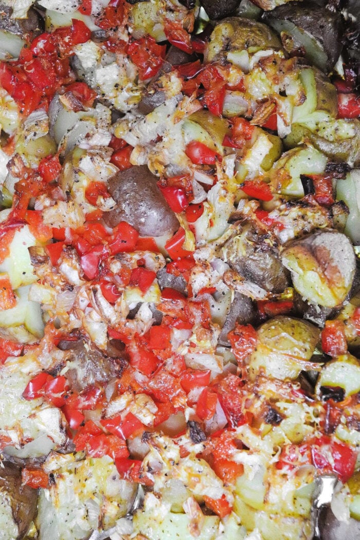 Smoked potatoes roasted to perfection, topped with chopped red bell peppers, onions, and savory seasoning.