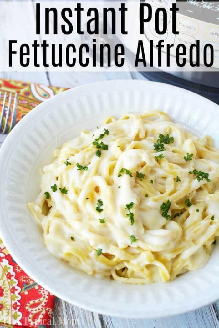 This Instant Pot fettuccine alfredo recipe is easy to make and a creamy buttery dinner your whole family is sure to love. Inexpensive pressure cooker meal. #instantpot #instantpotrecipes #alfredo #fettuccinealfredo #pasta #easy A white bowl of creamy Instant Pot fettuccine Alfredo topped with parsley, with an Instant Pot in the background.