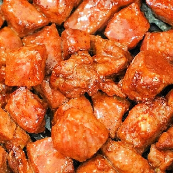 Close-up of bite-sized, glazed, and seared steak tips cooked in the oven.