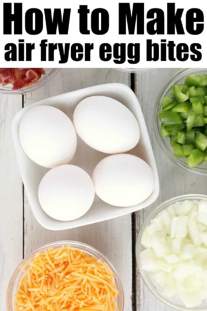 How to make air fryer egg bites filled with bacon, cheese and onions are the best low carb and keto breakfast idea ever! Like Starbucks egg bites but customized! #airfryer #airfryerrecipes #ninjafoodirecipes #eggbites #starbuckseggbites #airfryereggbites Four eggs in a bowl surrounded by chopped green pepper, onions, shredded cheese, and bacon—with air fryer egg bites recipe text above.
