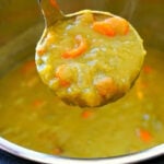 A ladle scoops thick Instant Pot Split Pea Soup Recipe with carrots from an Instant Pot.