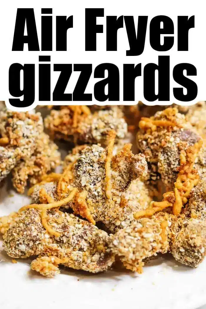 Close-up image of fried chicken gizzards covered in a light breading on a white surface, with the text "Air Fryer Chicken Gizzards" in bold black letters at the top. The gizzards appear crispy and seasoned.