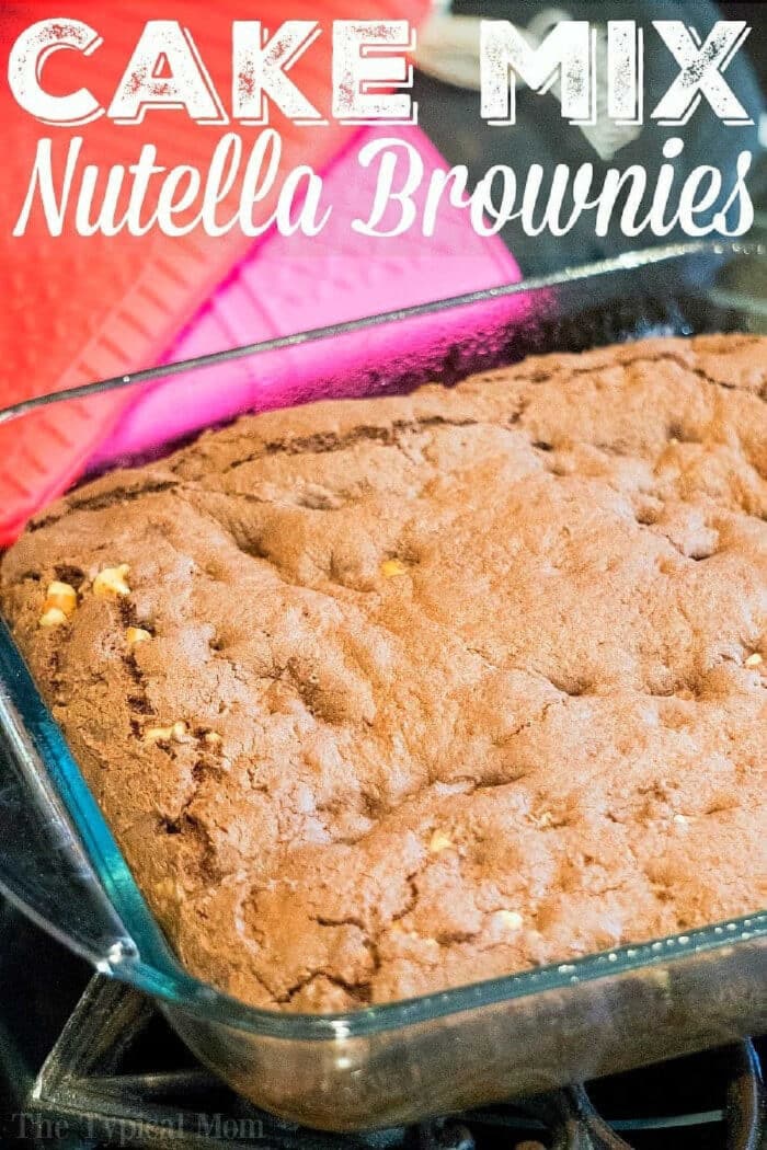 A glass baking dish filled with freshly baked Nutella brownies made from Devil's Food cake mix, with a red oven mitt beside it.