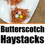 Three butterscotch haystacks shaped into festive nests hold colorful candy eggs on a white plate, perfectly displayed for Easter.