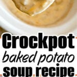 A spoonful of creamy Crockpot loaded baked potato soup above a bowl, topped with cheese, bacon, and green onions.