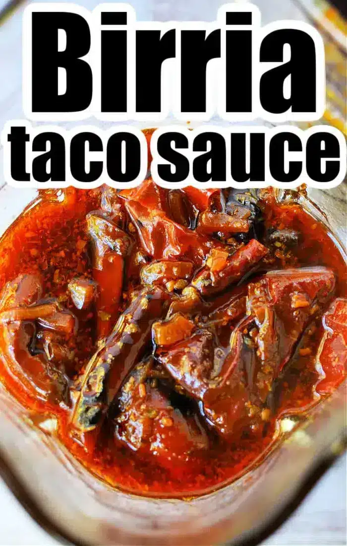 A close-up of Birria Tacos Sauce in a glass container reveals its rich, chunky texture with visible pieces of peppers and spices. Bold lettering at the top proudly declares "Birria taco sauce.