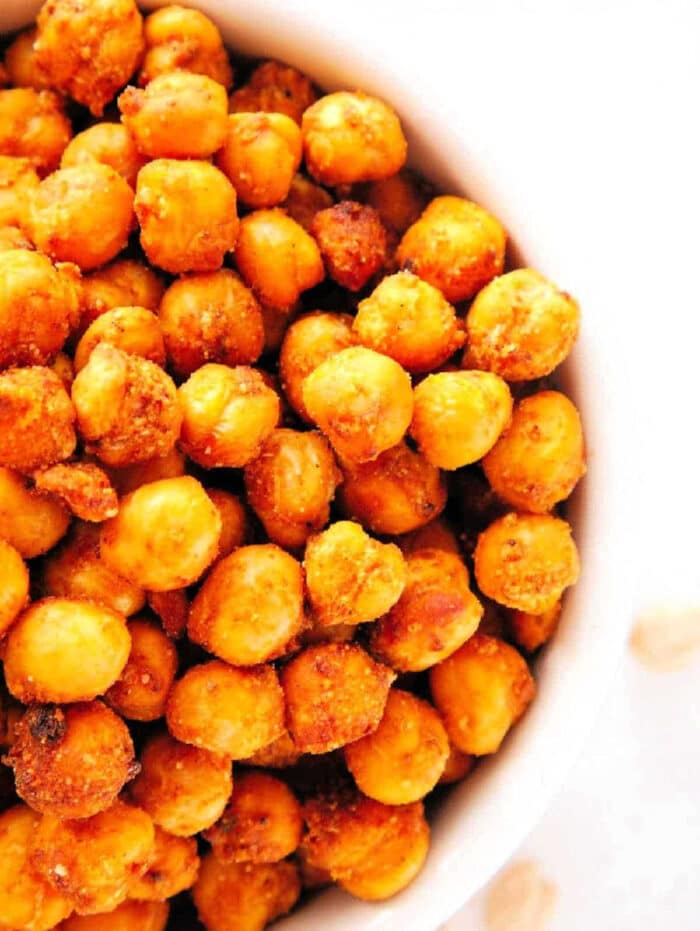 A bowl filled with crispy, air fryer chickpeas seasoned with flavorful spices.