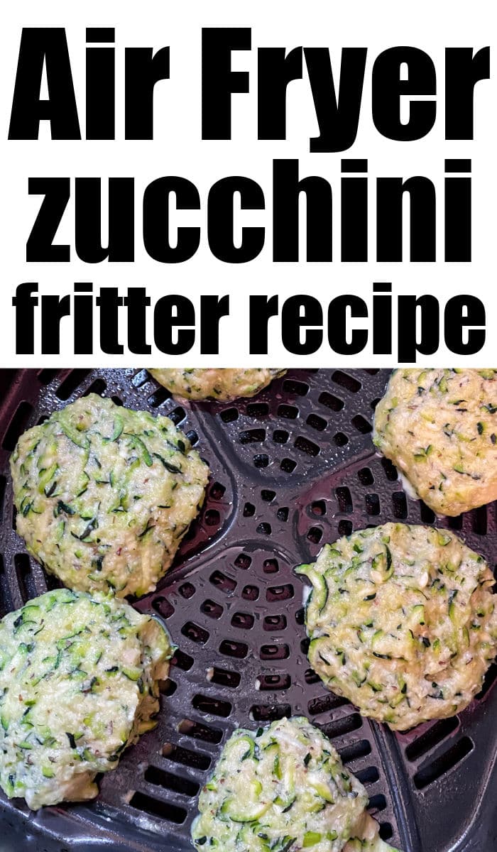 Air fryer zucchini fritters are arranged in an air fryer basket, ready to be cooked.