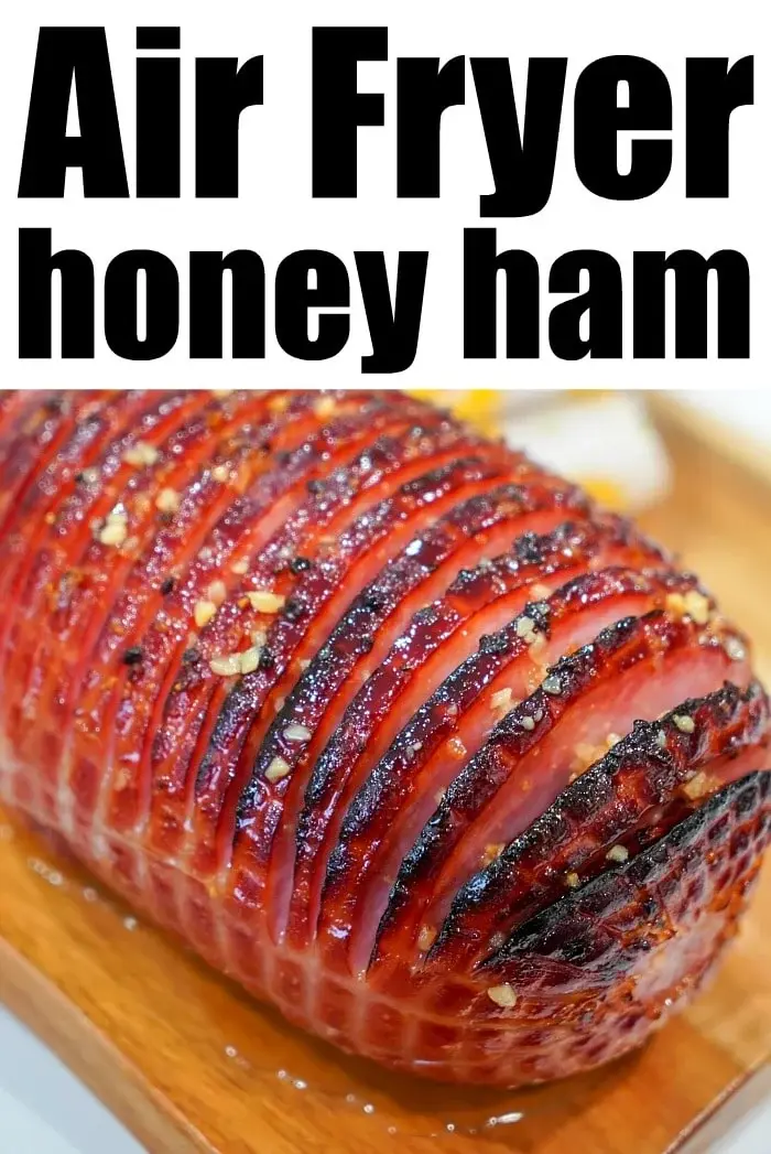 A close-up of a honey-glazed air fryer ham with a caramelized exterior. The ham has a crosshatch pattern and appears to be cooked to perfection. Text above the ham reads "Air Fryer honey ham.