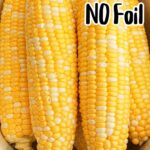 A crockpot is filled with ears of corn. Text overlay reads "Crockpot Corn on the Cob NO Foil" in large black and white letters.