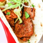 A close-up of a pork taco in a flour tortilla, filled with seasoned pork tenderloin, lettuce, and diced vegetables. The image features the text "KILLER! for Taco Tuesday" at the top and "Pork Tenderloin Tacos" at the bottom.