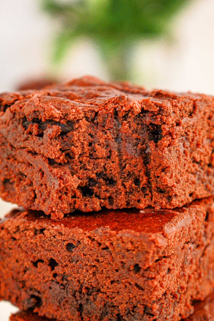 Close-up of two stacked black bean brownies made with brownie mix with a soft, crumbly texture, perfectly showcasing the rich mix of flavors.