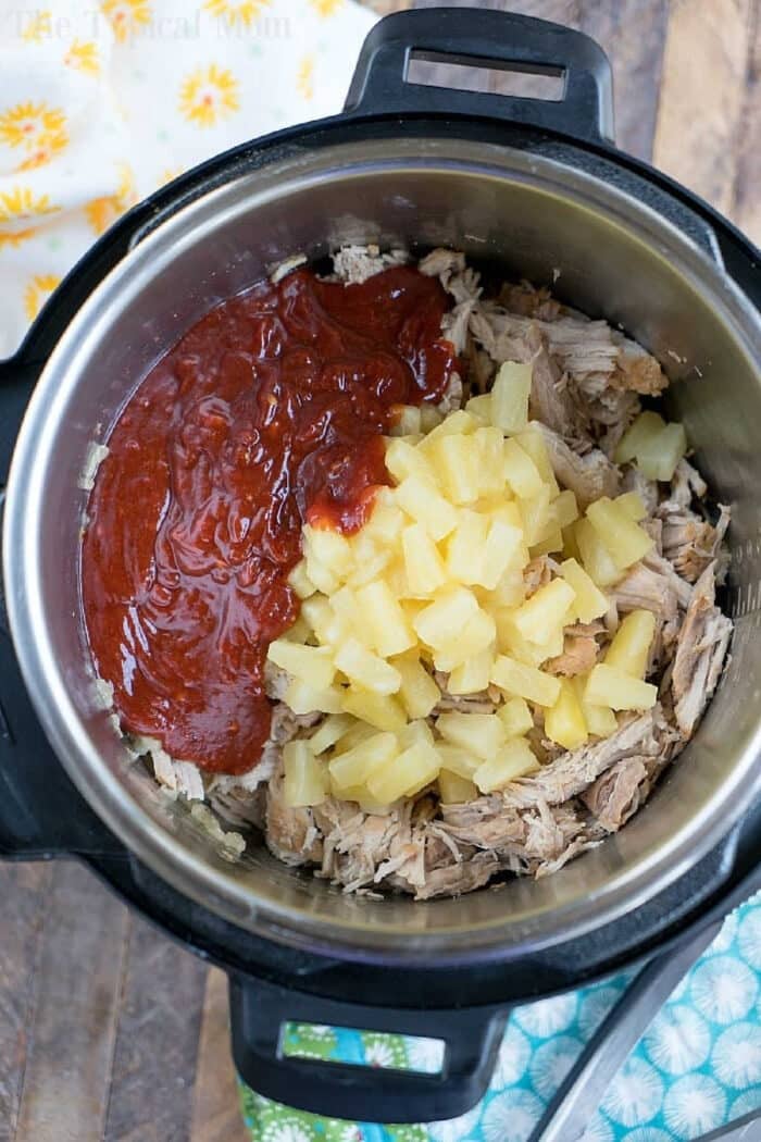 Instant Pot Hawaiian pulled pork features shredded pork, pineapple chunks, and barbecue sauce cooked together for a sweet and savory dish.