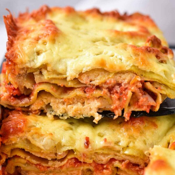 Two slices of cheesy, baked lasagna with layers of pasta, tomato sauce, and melted cheese—perfect alongside our baked frozen ravioli for a comforting meal.