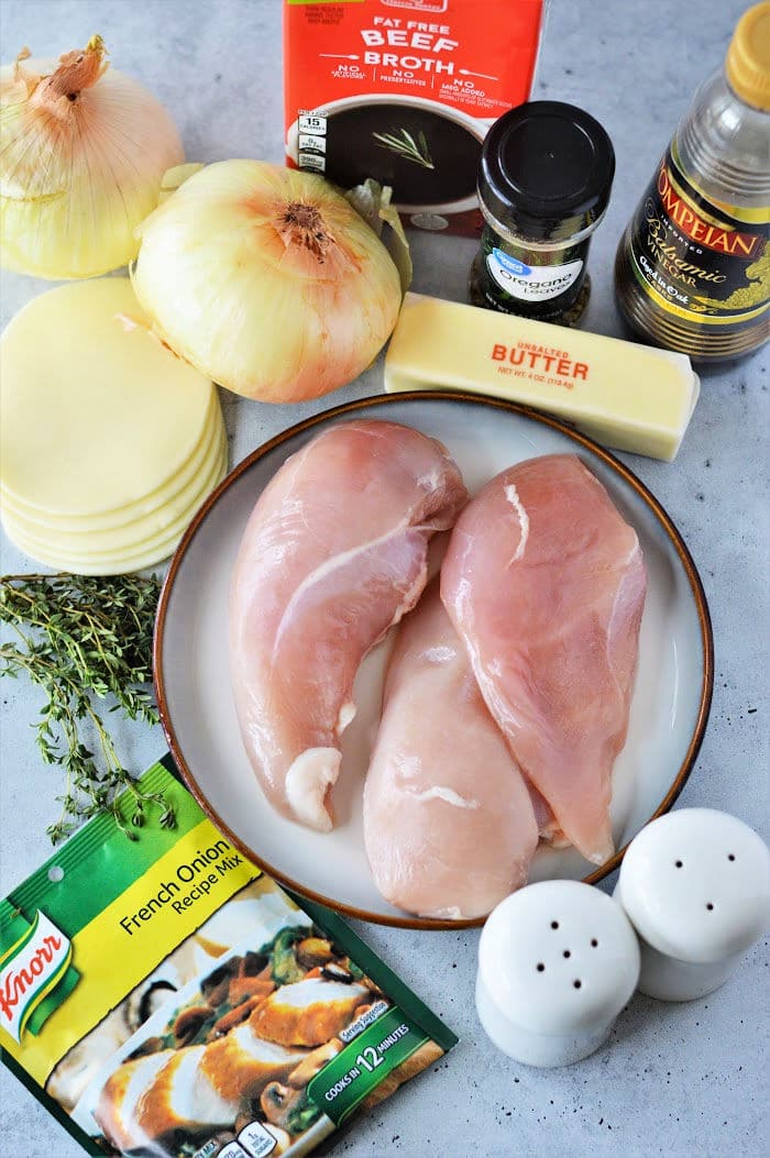 Raw chicken breasts, onions, cheese, beef broth, butter, olive oil, thyme, seasoning, and French onion soup mix come together for a delicious Instant Pot French Onion Chicken dinner.