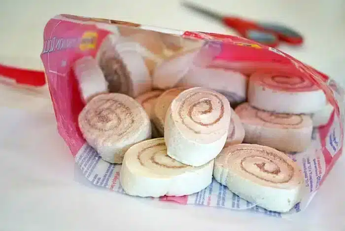 Open bag of packaged cinnamon swirl marshmallow snacks on a table, with scissors in the background&mdash;perfect for pairing with homemade monkey bread muffins.
