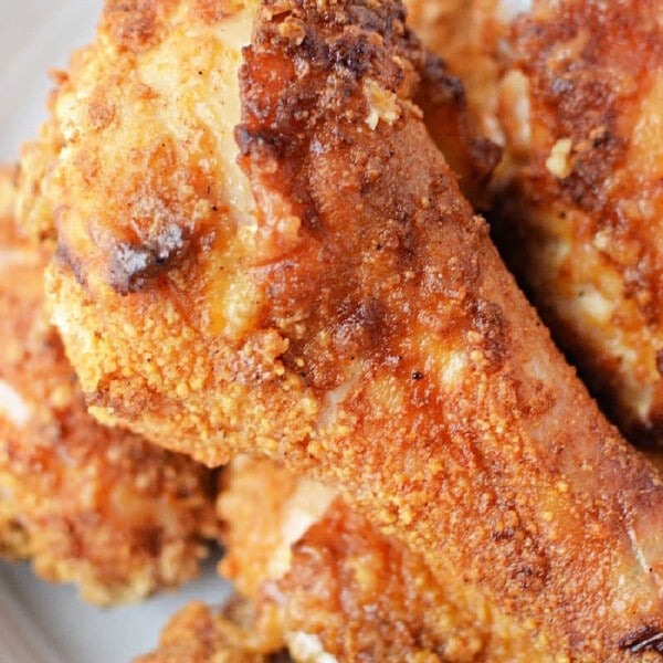 A plate of crispy oven-fried chicken with a golden-brown crust, reminiscent of classic fried chicken.