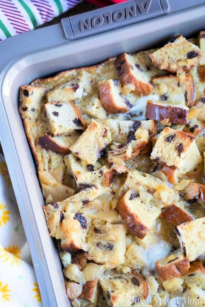 A baking pan filled with chunky bread pudding made from chocolate chip and raisin bread pudding.