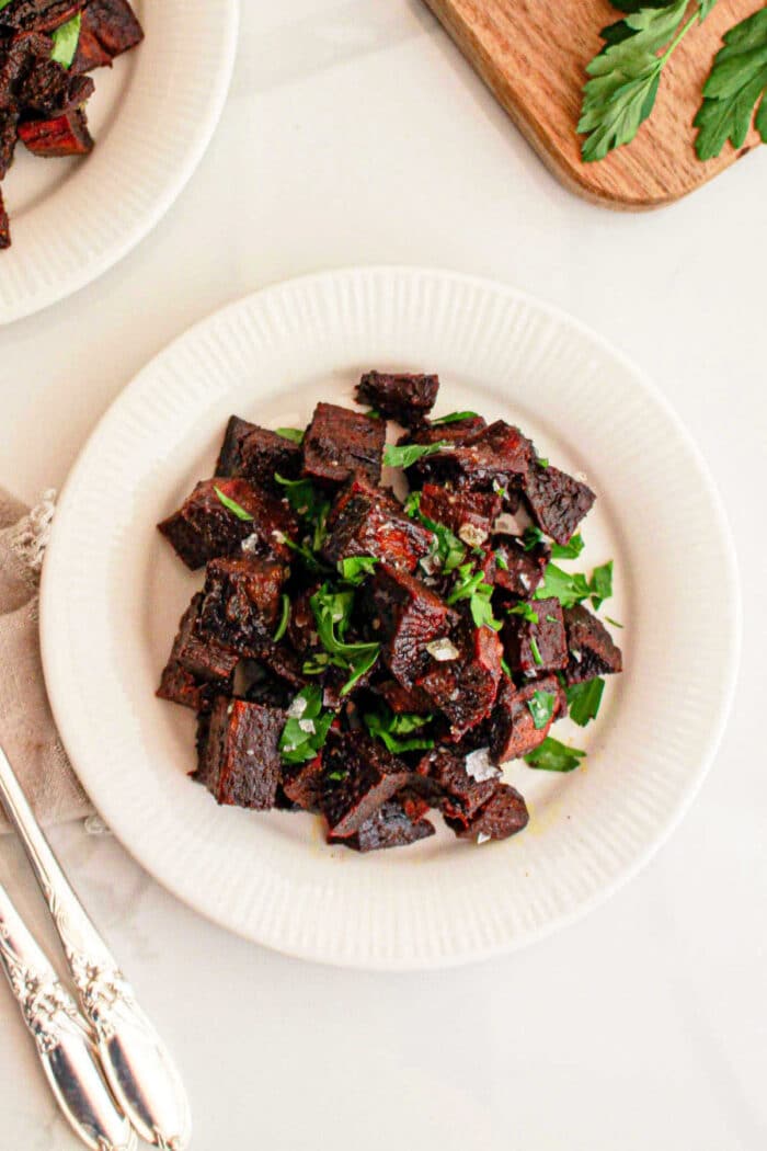 A white plate filled with crispy purple sweet potato, ideal for those seeking an exciting new recipe twist.