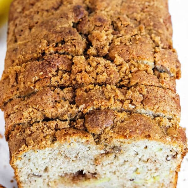 A sliced loaf of banana bread with a crumbly, golden-brown streusel topping, made using a classic Bisquick banana bread recipe.