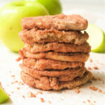 A stack of cinnamon sugar cookies with air fryer apples and green apples in the background.