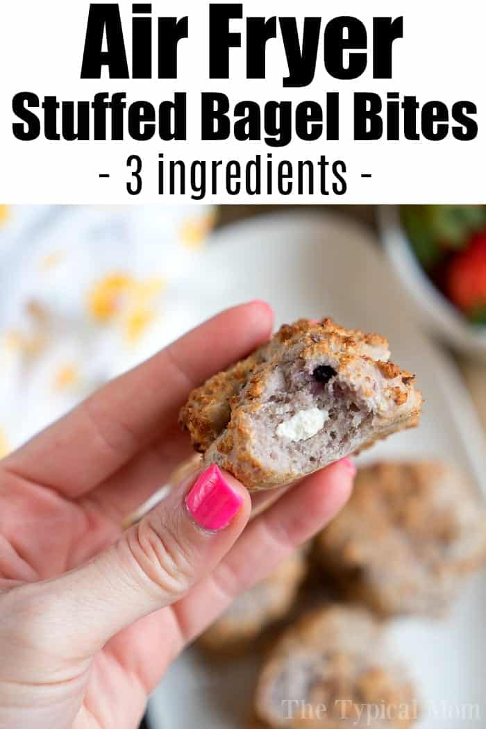 A hand holding a stuffed bagel bite with a creamy filling; text reads Bagel Bites Air Fryer - 3-ingredient Air Fryer Stuffed Bagel Bites.
