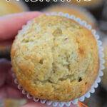 Close-up of a hand holding an Easy Banana Muffin, with text reading 2 Banana Muffins—Moistest Recipe!.