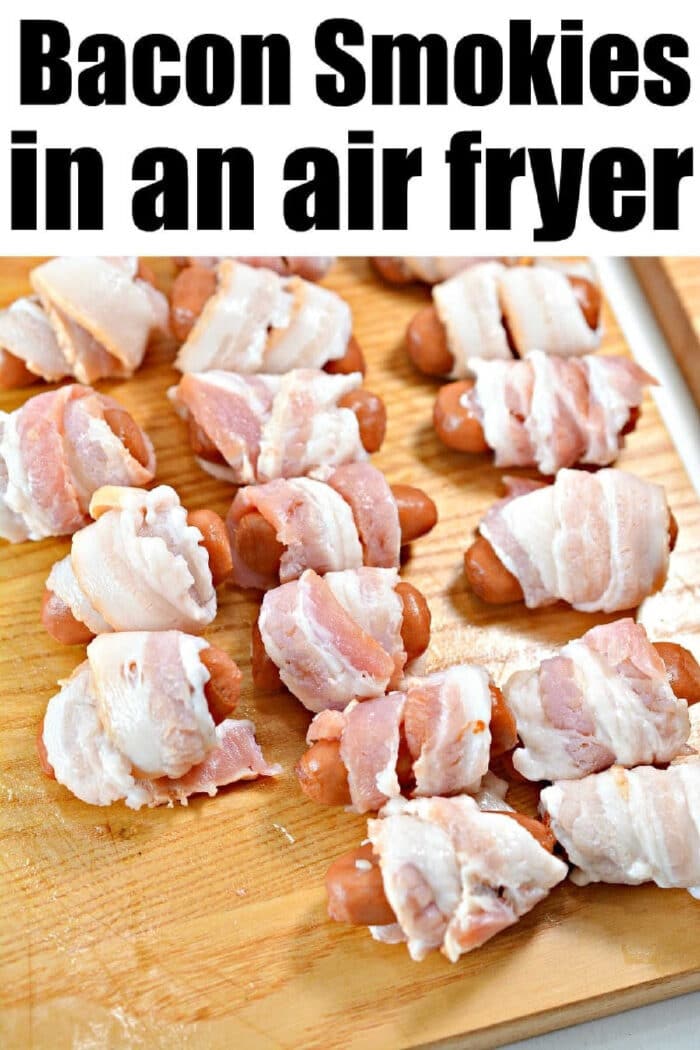 Air fryer bacon wrapped smokies arranged on a wooden cutting board, prepped and ready for perfectly crispy cooking.