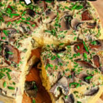 A sliced mushroom instant pot quiche garnished with chives sits on a wooden board. Text reads Instant Pot Quiche.