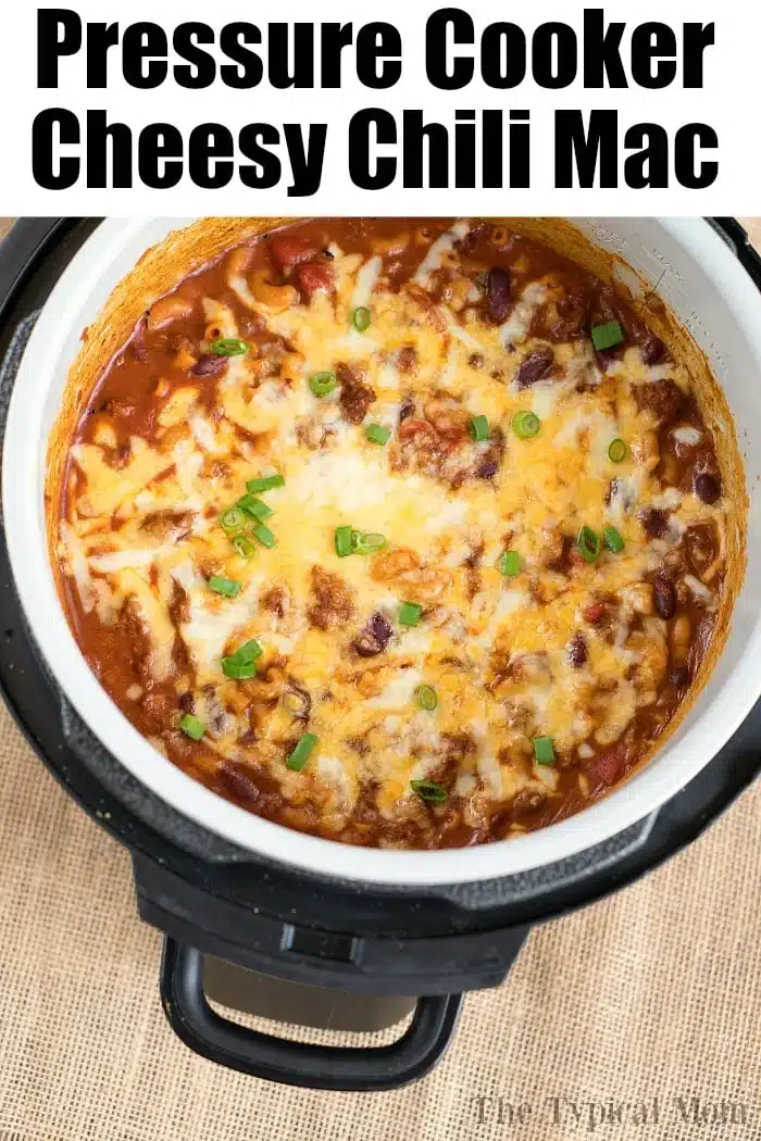 A Ninja pressure cooker filled with cheesy chili mac, topped with melted cheese and chopped green onions&mdash;perfect for fans of easy ninja pressure cooker recipes.