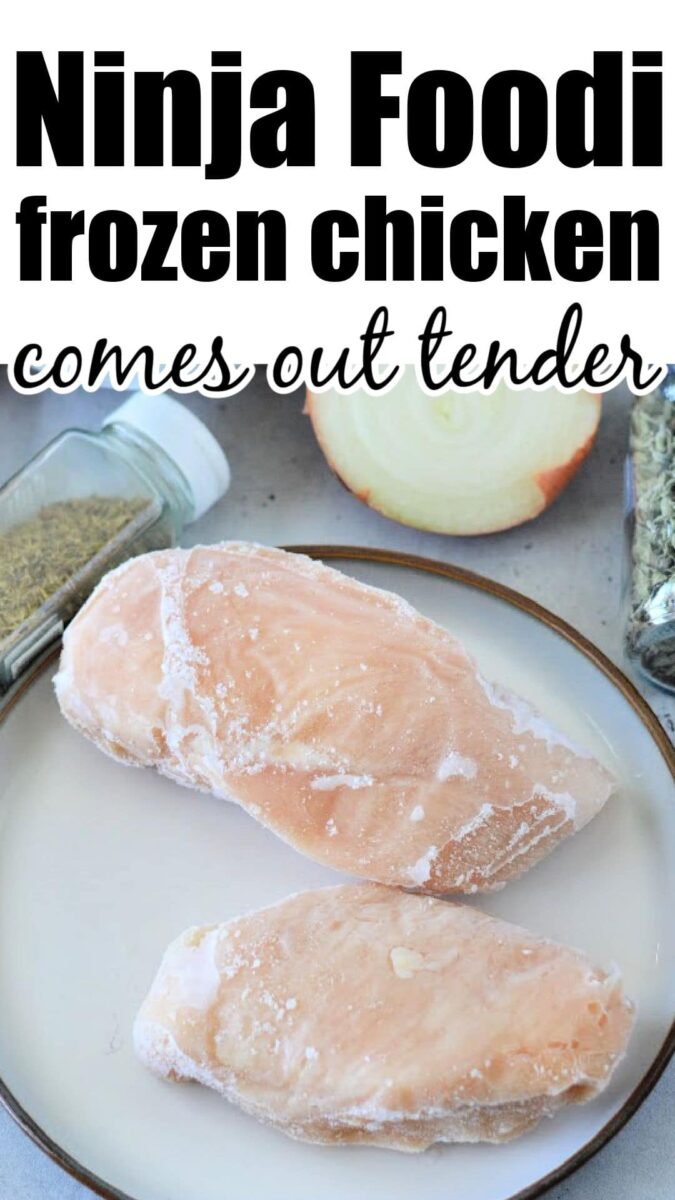 Two frozen chicken breasts on a plate with seasonings and an onion in the background&mdash;perfect ingredients for quick and tasty Ninja pressure cooker recipes.