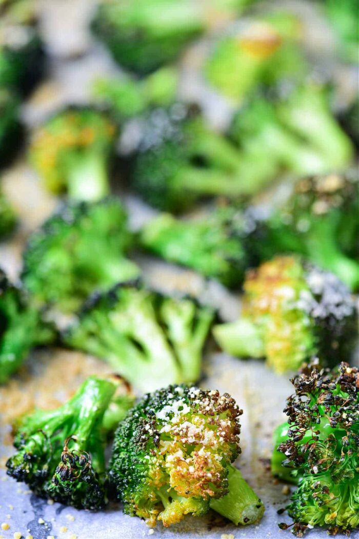 Bake frozen broccoli florets on a baking sheet, sprinkled with seasoning for deliciously roasted veggies with slightly crispy edges.